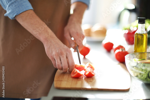 Man cooking dinner in kitchen
