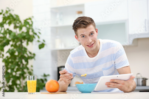 Handsome man with tablet an...