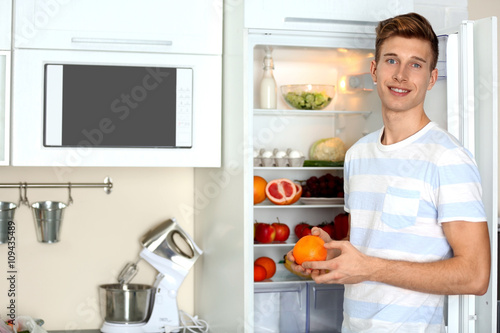 Handsome man taking food fr...