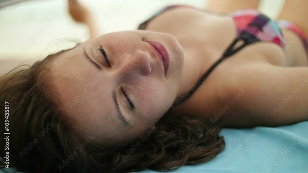 Sensual white girl relaxing at the beach, lying under a dark scarf blowing on the wind, looking at camera. Slow motion.
Sensual white girl relaxing at the beach, lying under a dark scarf blowing on the wind, looking at camera. Slow motion.