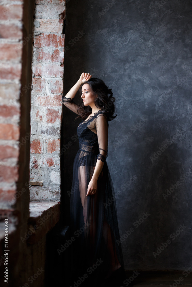 Portrait of gorgeous young brunette woman in a transparent black dress Portrait of gorgeous young brunette woman in a transparent black dress