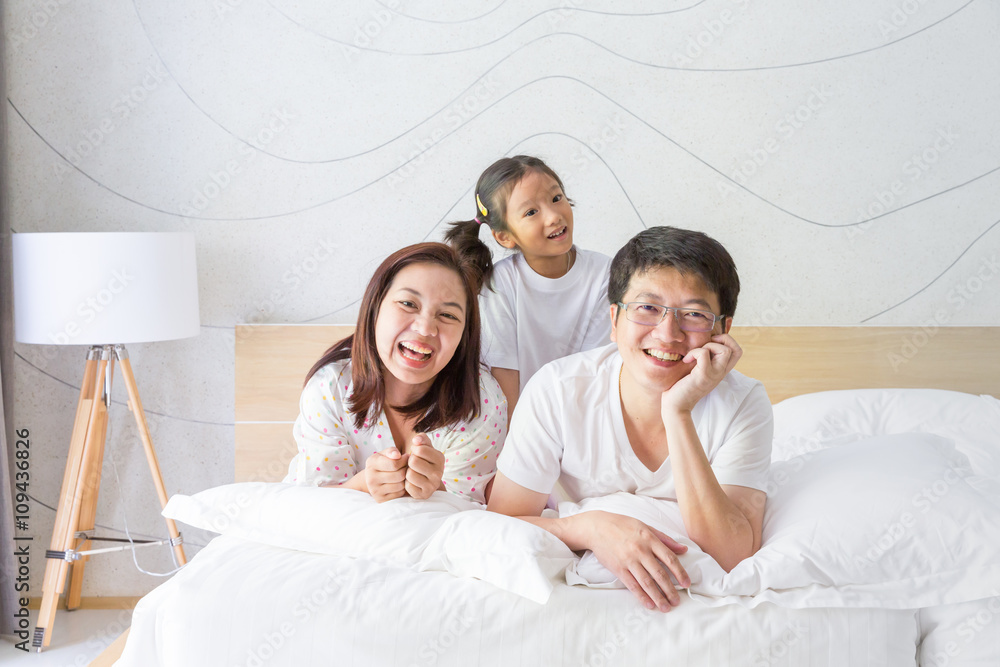 Happy asian family, mother, father and daughter resting on the w Happy asian family, mother, father and daughter resting on the w