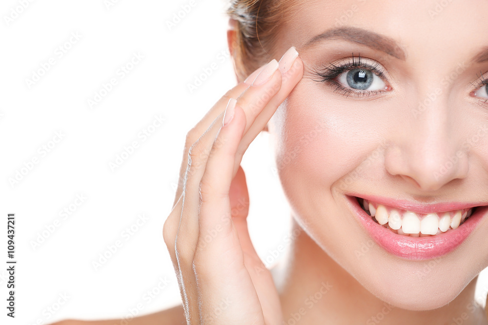 Young woman touching her face isolated on white background Young woman touching her face isolated on white background
