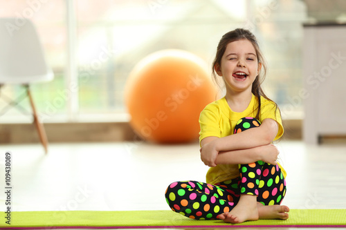 Little funny girl sitting o...
