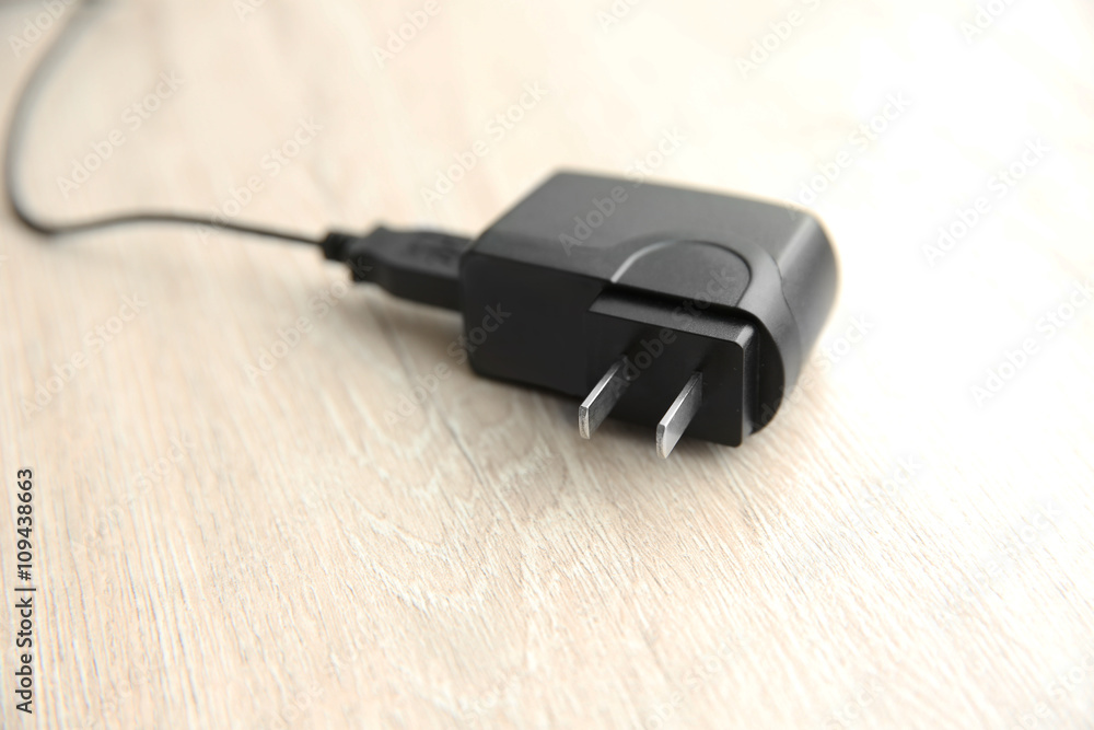 Power plug on wooden table Power plug on wooden table