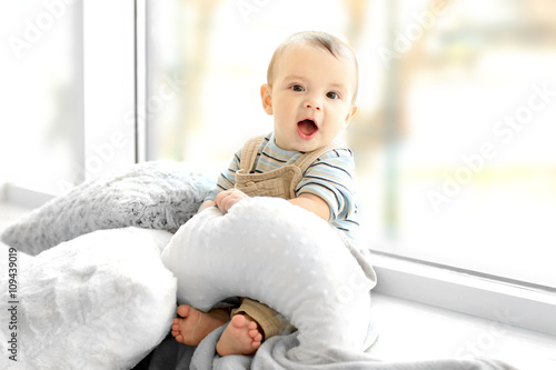 Little baby boy with pillow...