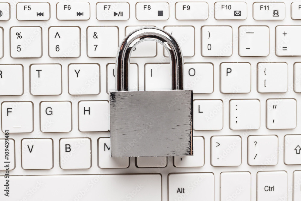 padlock and white computer keyboard on the wooden office table. privacy protection, encrypted connection concept padlock and white computer keyboard on the wooden office table. privacy protection, encrypted connection concept
