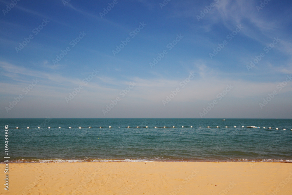 Sea wave on the beach with the blue sky