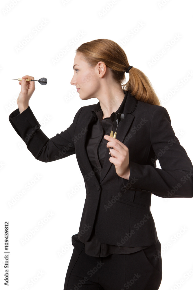 Confident businesswoman throwing dart
