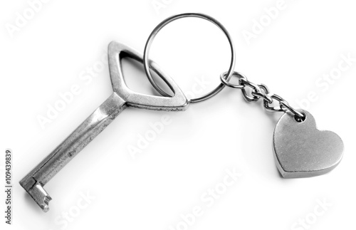 Key with heart trinket, isolated on white