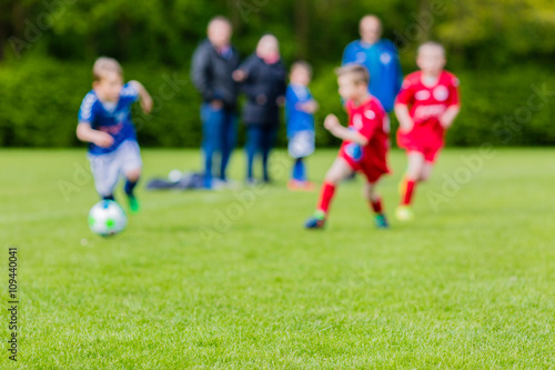 Blurred kids playing youth football match © Mikkel Bigandt