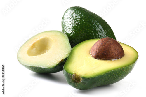 Halves of fresh avocado isolated on white