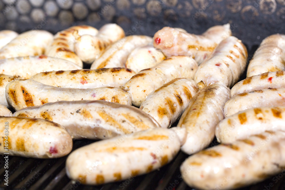 cooking sausages on a grill in the restaurant cooking sausages on a grill in the restaurant
