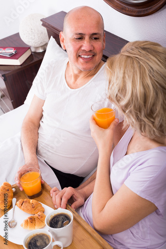 adults posing with coffee and pastry photo