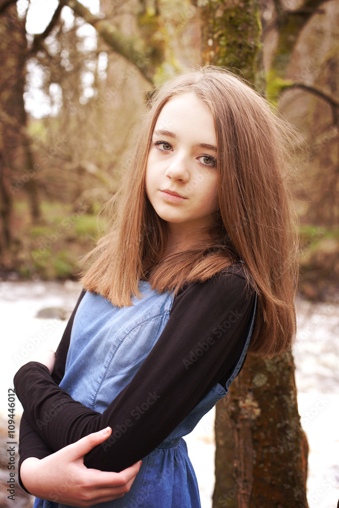 Pretty teenage girl leaning against a tree Pretty teenage girl leaning against a tree