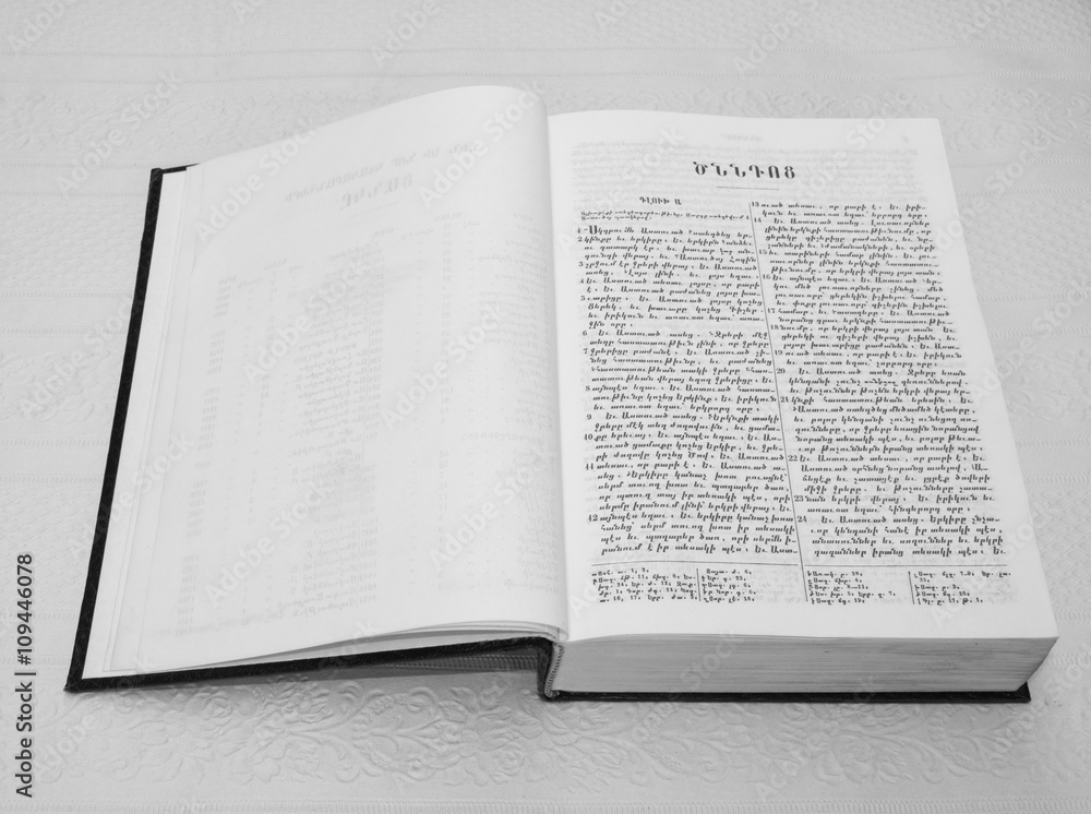 Bible open book with text on white paper, black white picture Bible open book with text on white paper, black white picture