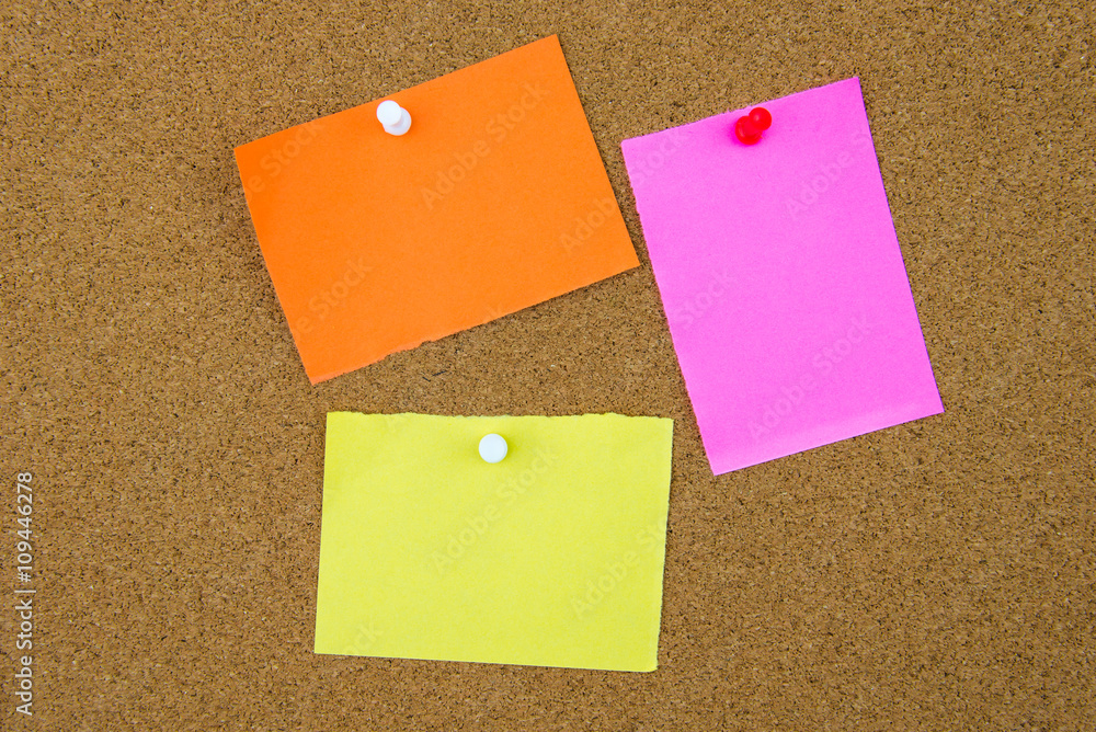 Blank paper notes pinned on cork board Blank paper notes pinned on cork board