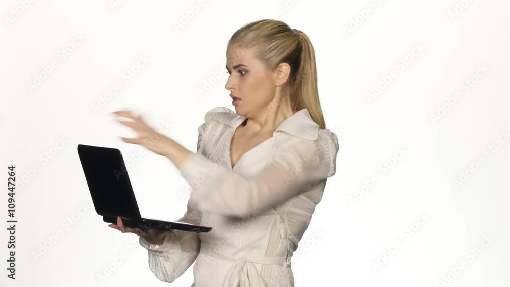 Very angry businesswoman working at a computer. White Very angry businesswoman working at a computer. White