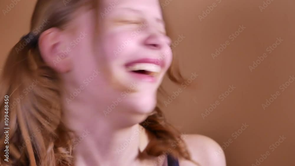 Closeup portrait of a funny attractive laughing teen girl. 4K UHD Closeup portrait of a funny attractive laughing teen girl. 4K UHD