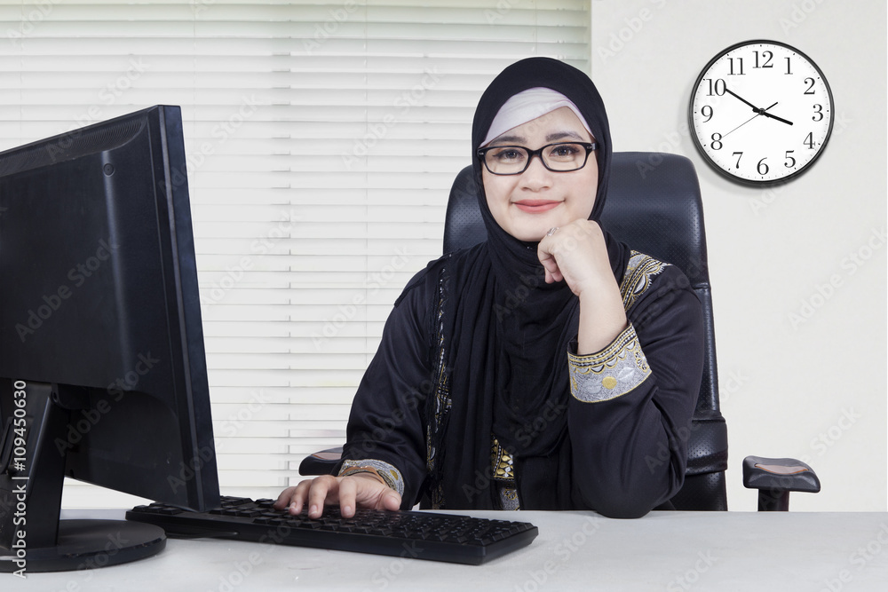 Confident Arabian worker sits in office Confident Arabian worker sits in office