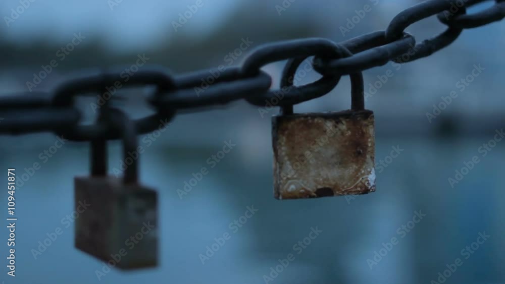 The manifestation of chains and locks on the background passing boats. The focus from the boat to the lock and chain. The manifestation of chains and locks on the background passing boats. The focus from the boat to the lock and chain.