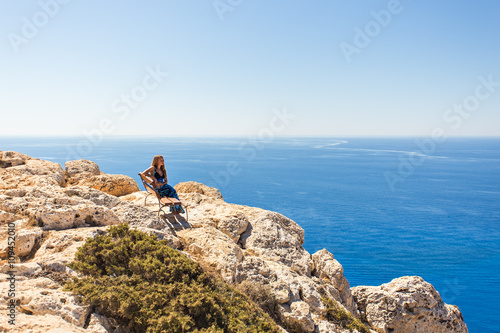 Pretty girl stay on the top of mountain and see to horizon with beautiful background. 