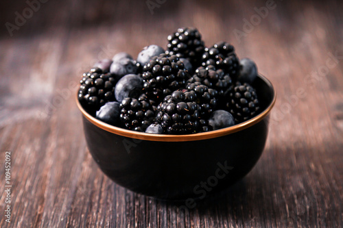 blueberries and raspberries on a wooden background