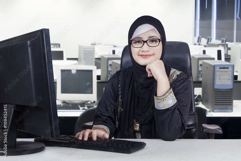 Young Arabian worker smiling in office Young Arabian worker smiling in office