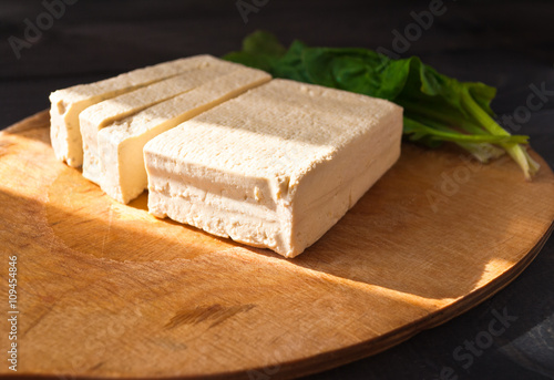 Slices of raw tofu and spinach