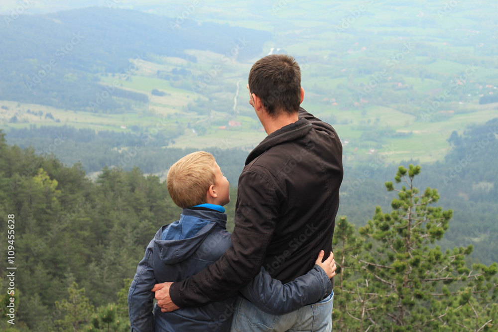 Family and togetherness concept. Father and son enjoying mountain view. Traveling with kids