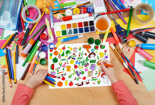 cartoon food collection  fruit and vegetables child drawing  top view hands with pencil painting picture on paper  artwork workplace