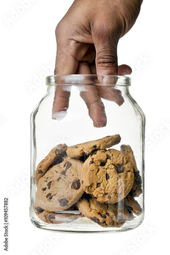Fototapeta hand picking cookies in the jar