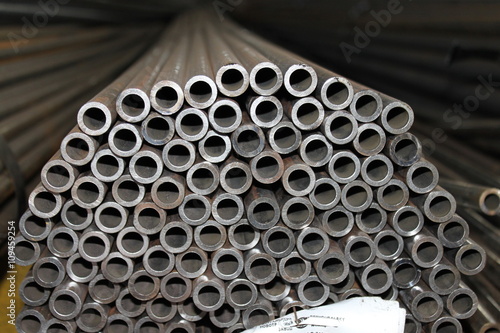 Steel tube. Metal pipe. Steel rolled bar. Stuck of steel pipes. Steel pipe bundle in industrial stockyard. © alexalmighty
