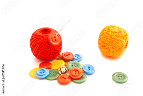 needle, colored buttons and thread