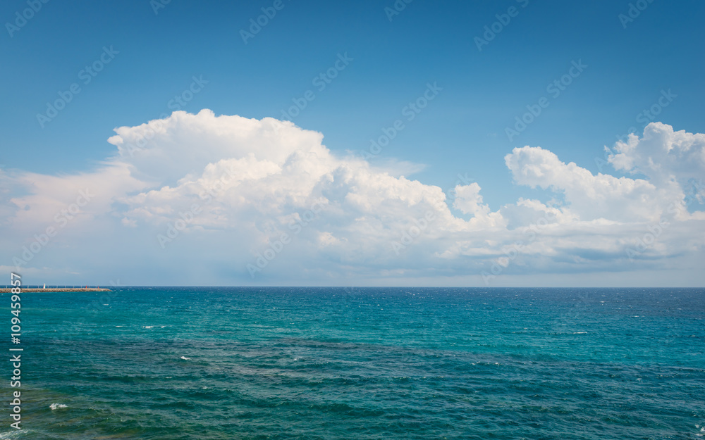 Ligurian Sea. Seascape Italy. White clouds on a blue sky. Great summer vacation day.