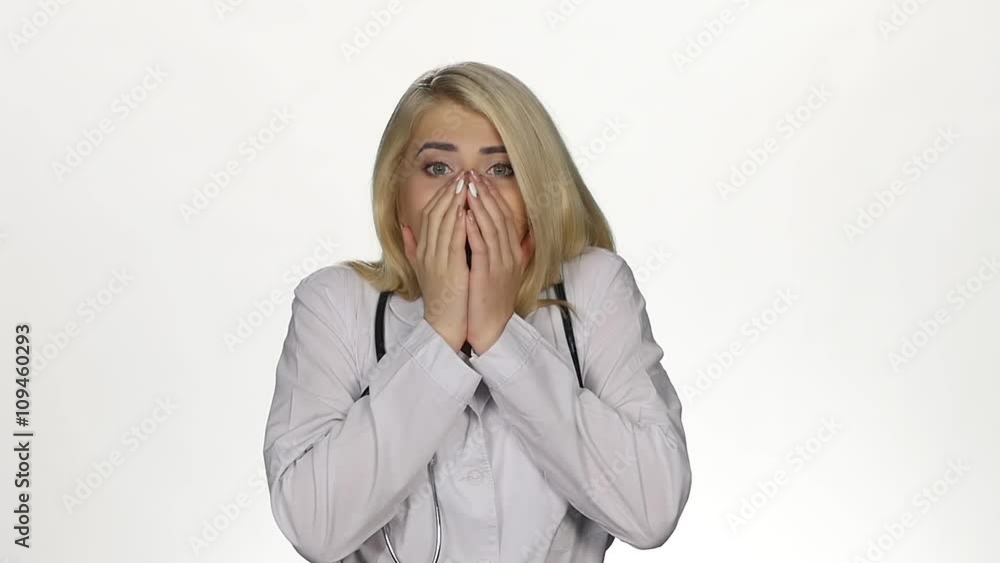 Shocked young female doctor. White. Slow motion Shocked young female doctor. White. Slow motion