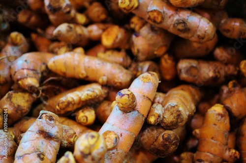 Orange turmeric tubers in bulk at a farmers market in Singapore