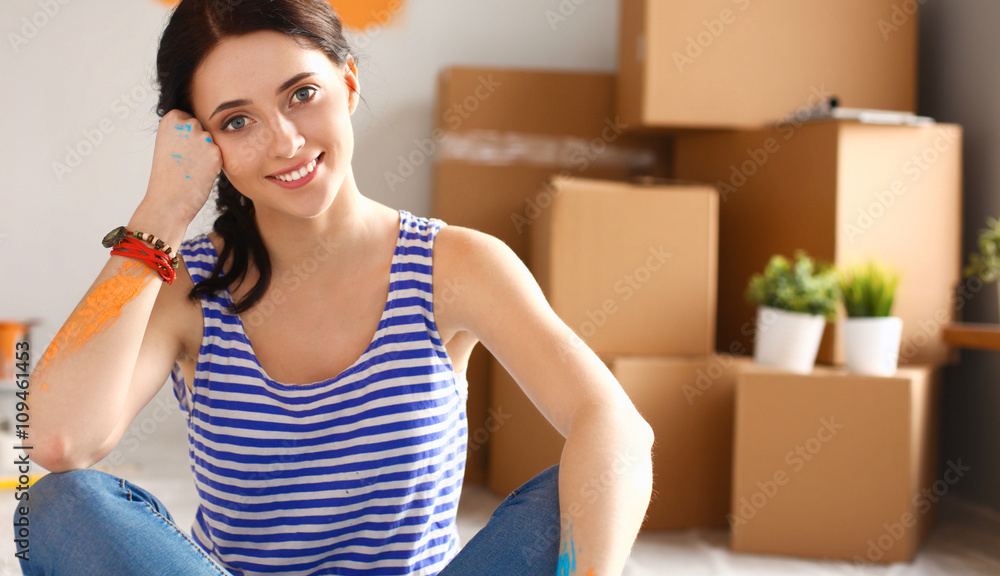 Young woman portrait while painting new apartment 