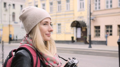 Tourist taking photo of old street at the retro film camera