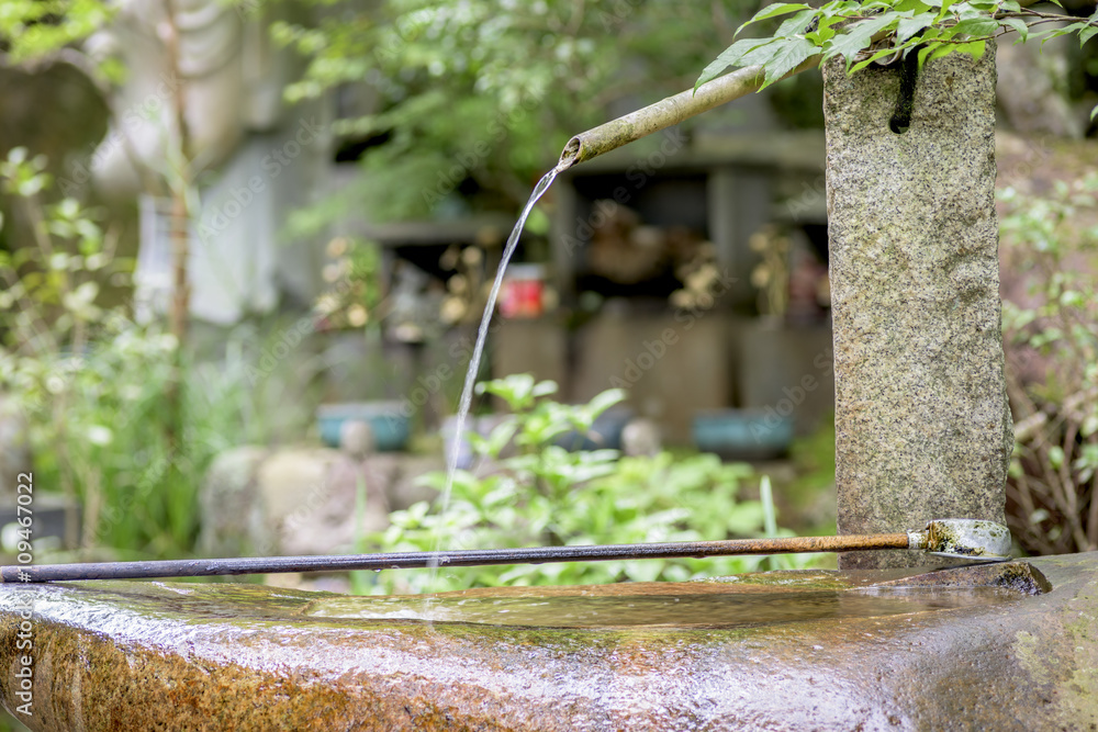 Spout of water at a temple in Japan with dipper