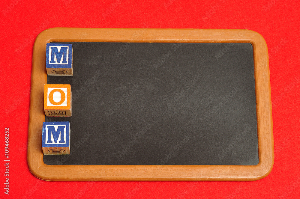 mom spelled with colorful alphabet blocks and a red heart on a blackboard mom spelled with colorful alphabet blocks and a red heart on a blackboard