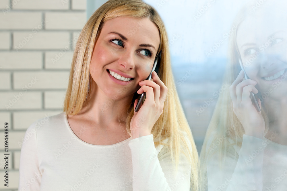 Portrait of happy young Woman Talking On Mobile Phone, standing Portrait of happy young Woman Talking On Mobile Phone, standing