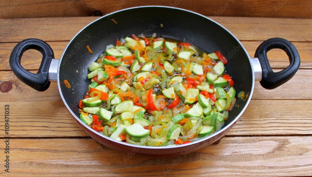 Vegetables stewed fried in oil in a frying pan Vegetables stewed fried in oil in a frying pan