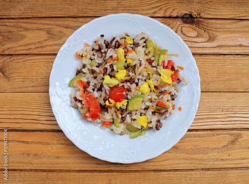 Rice salad with vegetables, seafood and flowers tagetes