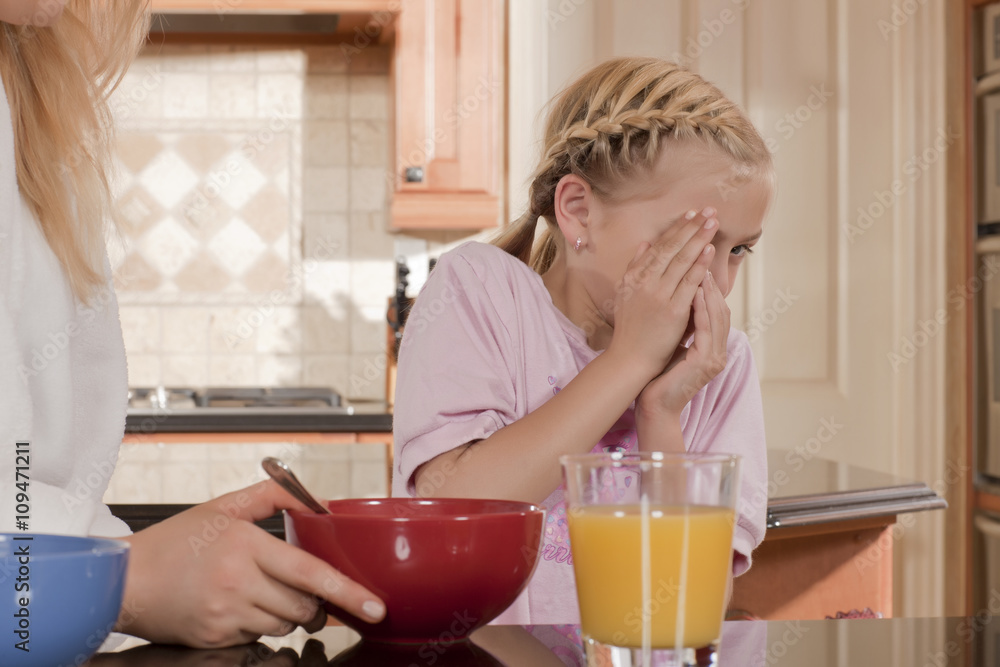 girl disliking her breakfast girl disliking her breakfast