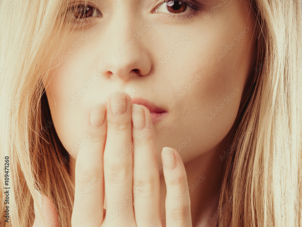 Surprised woman face covering her mouth with hand Surprised woman face covering her mouth with hand