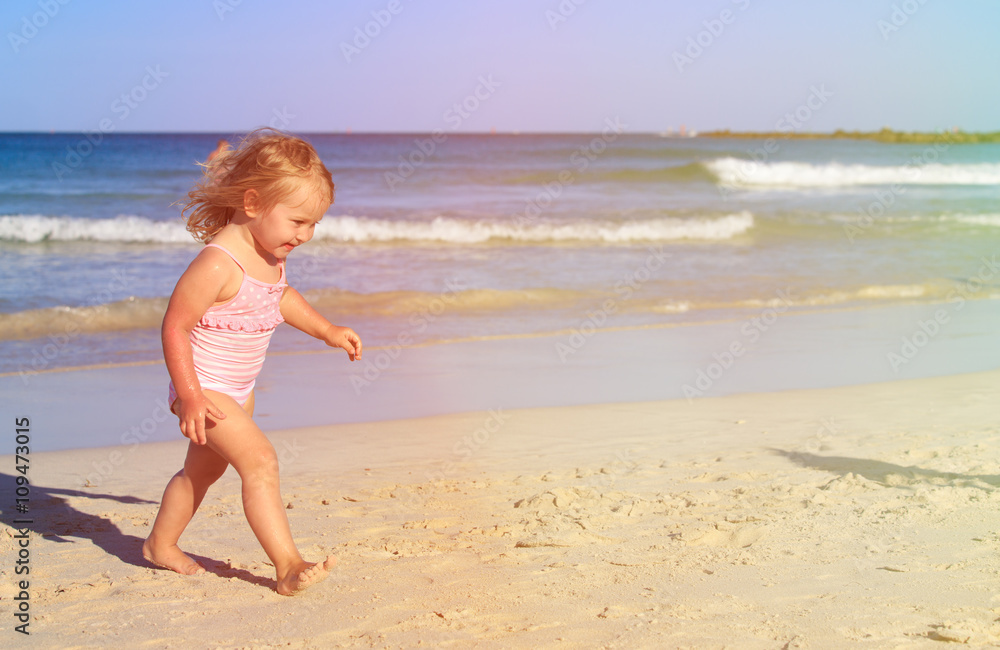 cute little girl play with water on beach cute little girl play with water on beach