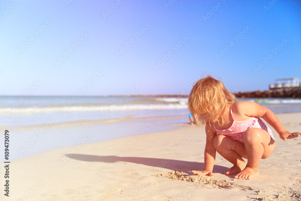 little girl play with sand on beach little girl play with sand on beach
