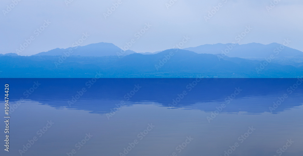 group of blue mountain layers with water reflection in Thailand