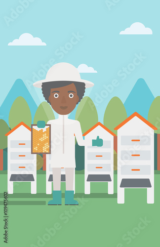 Bee-keeper at apiary.